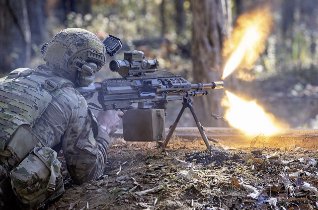 Soldier firing a machine gun.