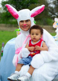 Young child posed with an adult dressed as the Easter Bunny